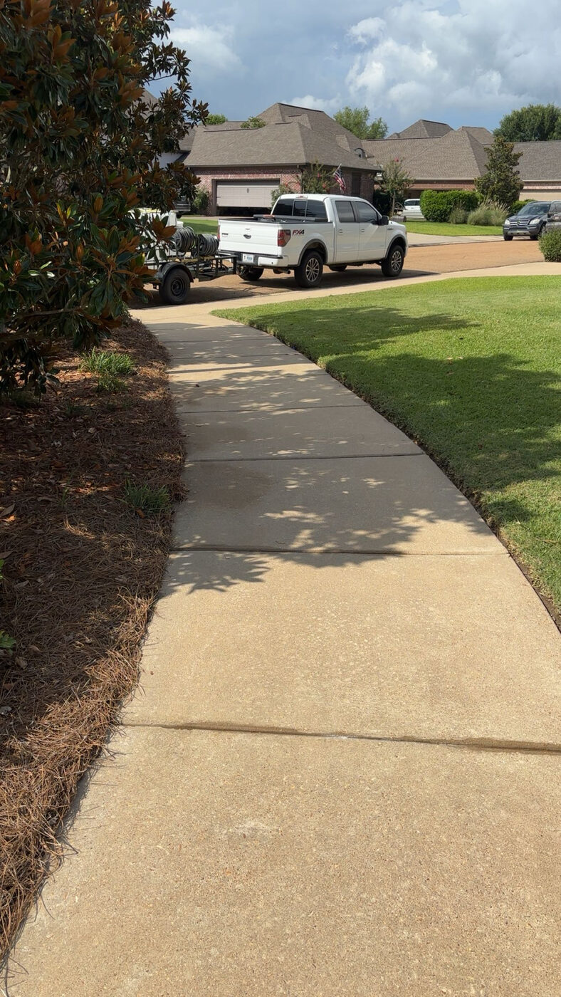 Blast Off Pressure Washing truck and trailer equipment on a freshly cleaned walkway